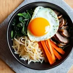 한식 비빔밥 레시피 - **A Vibrant and Perfectly Arranged Bibimbap Bowl.**
    A high-resolution, top-down food photography...